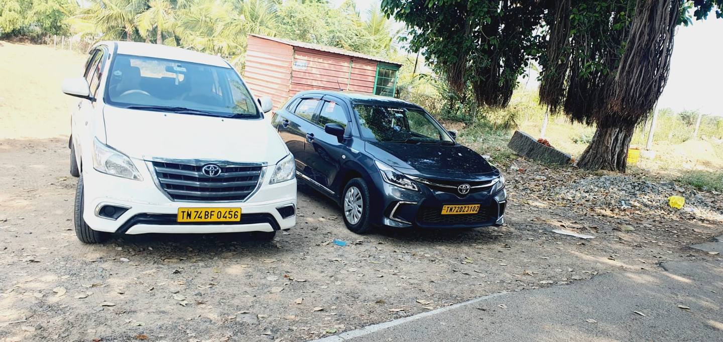 Our white Toyota Innova and grey Toyota Glanza parked together